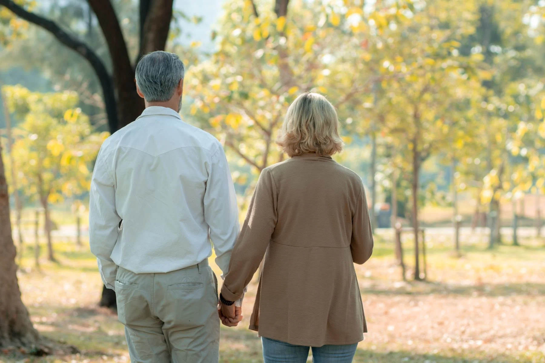 A couple walking together through a park