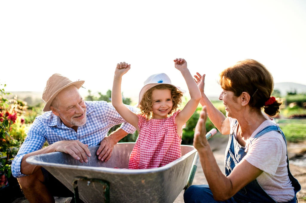Grandparents in the garden with their family