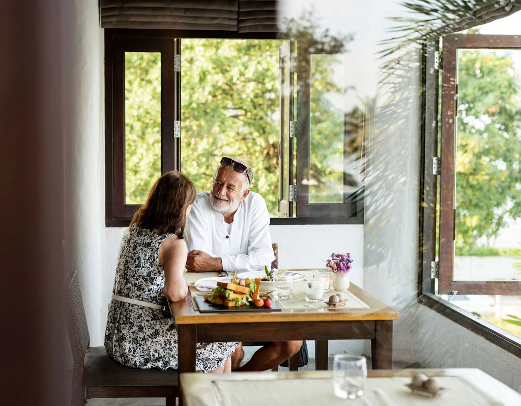 A couple reviewing their plan over dinner