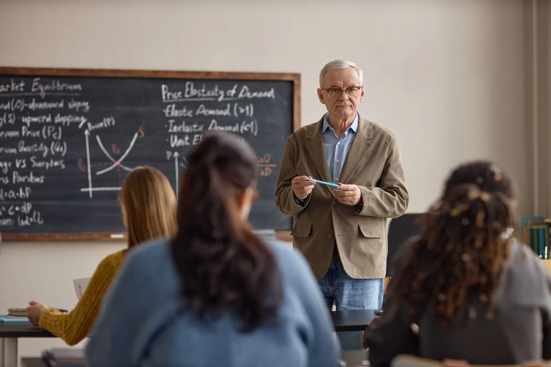 An educator speaking with students in a classroom